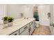 Well-lit bathroom with a double sink vanity, white cabinets, and a shower-tub combination at 8409 Rush Creek Ave, Littleton, CO 80125