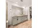 Spacious bathroom features double vanity sinks, tiled floors, and ample storage at 8409 Rush Creek Ave, Littleton, CO 80125