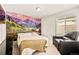 Bedroom with a cozy bed, accent wall art, and relaxing armchair, creating a serene retreat at 8409 Rush Creek Ave, Littleton, CO 80125