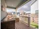 Inviting covered porch with comfortable seating, perfect for enjoying the outdoors at 8409 Rush Creek Ave, Littleton, CO 80125