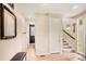 Inviting entryway with light wood floors, neutral paint, and access to the staircase at 8409 Rush Creek Ave, Littleton, CO 80125