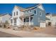 Charming two-story home with blue siding and a well-manicured front yard at 8409 Rush Creek Ave, Littleton, CO 80125