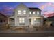 Charming two-story home featuring a covered porch, white siding, and tasteful landscaping at 8409 Rush Creek Ave, Littleton, CO 80125