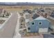 A charming two-story home with blue siding, a cozy front porch, well manicured landscaping and solar panels at 8409 Rush Creek Ave, Littleton, CO 80125