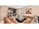 Cozy living room features a large TV, a comfortable sectional sofa, and natural light at 8409 Rush Creek Ave, Littleton, CO 80125