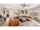 Comfortable living room featuring modern furnishings, a ceiling fan, and large window at 8409 Rush Creek Ave, Littleton, CO 80125