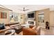 Stylish living room showcasing a modern fireplace, leather furniture, and ample natural light at 8409 Rush Creek Ave, Littleton, CO 80125