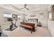 Bright main bedroom with tray ceiling and ensuite bathroom at 8409 Rush Creek Ave, Littleton, CO 80125