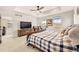 Spacious main bedroom with tray ceiling, large bed, and ensuite bathroom at 8409 Rush Creek Ave, Littleton, CO 80125