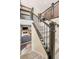 Staircase features dark wood railings, and neutral carpet with access to the living room at 8409 Rush Creek Ave, Littleton, CO 80125
