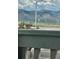 Scenic street view of distant mountains and green open space from the property at 8409 Rush Creek Ave, Littleton, CO 80125