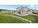 Expansive backyard features a lush lawn, patio area, garden, and views of the greenbelt at 9916 Sand Cherry Way, Highlands Ranch, CO 80129