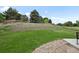 Terraced backyard with lush lawn, retaining walls, and a border of decorative pebbles at 9916 Sand Cherry Way, Highlands Ranch, CO 80129