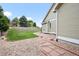Landscaped backyard with a stone walkway and retaining wall at 9916 Sand Cherry Way, Highlands Ranch, CO 80129