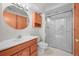 Bathroom featuring a wooden vanity, glass shower, and built-in cabinets at 9916 Sand Cherry Way, Highlands Ranch, CO 80129