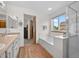 Bright bathroom featuring a soaking tub, glass shower, and a double sink vanity with wood-look floors at 9916 Sand Cherry Way, Highlands Ranch, CO 80129