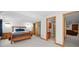 Spacious bedroom featuring wood floors, closet, and an en-suite bathroom at 9916 Sand Cherry Way, Highlands Ranch, CO 80129
