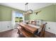Bright dining room with wooden table and bench seating under a modern chandelier at 9916 Sand Cherry Way, Highlands Ranch, CO 80129