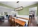 Bright dining room with a wooden table set, chandelier, and open layout to living area at 9916 Sand Cherry Way, Highlands Ranch, CO 80129