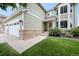 Inviting home entrance with brick accents, manicured lawn, and three car garage at 9916 Sand Cherry Way, Highlands Ranch, CO 80129