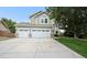 Two-story home with three-car garage, well-manicured lawn, and mature trees at 9916 Sand Cherry Way, Highlands Ranch, CO 80129