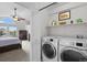 Convenient laundry area with modern washer and dryer, adjacent to the bedroom at 9916 Sand Cherry Way, Highlands Ranch, CO 80129