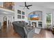 Living room with vaulted ceilings, a fireplace, and a cozy leather sectional sofa at 9916 Sand Cherry Way, Highlands Ranch, CO 80129