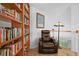 Reading nook with a built-in bookshelf and comfortable armchair at 9916 Sand Cherry Way, Highlands Ranch, CO 80129