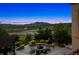 Backyard boasts a fire pit, mountain views, and lush landscaping at sunset at 15490 W Asbury Ave, Lakewood, CO 80228