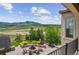 Landscaped backyard featuring a fire pit area with scenic mountain views at 15490 W Asbury Ave, Lakewood, CO 80228