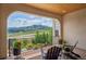 Cozy deck space with seating and views of mountains and landscaped yard at 15490 W Asbury Ave, Lakewood, CO 80228
