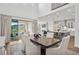 Spacious dining room adjacent to kitchen with views of the outdoor patio at 15490 W Asbury Ave, Lakewood, CO 80228
