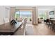Modern dining area with hardwood floors, opening to a deck and mountain views at 15490 W Asbury Ave, Lakewood, CO 80228