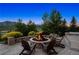 Inviting backyard fire pit with stone surround, seating and landscape views at 15490 W Asbury Ave, Lakewood, CO 80228