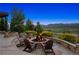 Stone patio features a built-in fire pit and seating, with gorgeous landscape views at 15490 W Asbury Ave, Lakewood, CO 80228