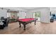 Game room featuring a pool table and a fitness center with glass doors to a workout room at 15490 W Asbury Ave, Lakewood, CO 80228