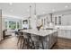 Bright open-concept kitchen featuring a large island, stainless steel appliances, and views at 15490 W Asbury Ave, Lakewood, CO 80228