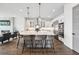 A spacious kitchen with large island, quartz countertops, modern appliances and hardwood flooring at 15490 W Asbury Ave, Lakewood, CO 80228
