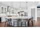 Modern white kitchen with island, stainless appliances and ample storage at 15490 W Asbury Ave, Lakewood, CO 80228