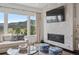 Modern living room with fireplace, large windows, and comfortable seating area at 15490 W Asbury Ave, Lakewood, CO 80228