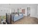 Open loft area featuring a comfortable seating area and bright, natural light at 15490 W Asbury Ave, Lakewood, CO 80228