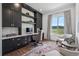 Well-lit home office featuring custom built-in cabinetry, a large window, and mountain views at 15490 W Asbury Ave, Lakewood, CO 80228