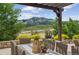 Outdoor patio dining area with pergola and scenic mountain views at 15490 W Asbury Ave, Lakewood, CO 80228