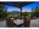 Outdoor patio with covered dining table, fire pit and picturesque mountain views at sunset at 15490 W Asbury Ave, Lakewood, CO 80228