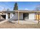 Backyard featuring white brick, covered patio, and open yard space at 3501 W 41St Ave, Denver, CO 80211