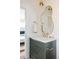 Bathroom vanity with marble countertops, gold fixtures, and a unique mirror at 3501 W 41St Ave, Denver, CO 80211