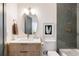 Modern bathroom with marble countertops, wooden vanity, and updated fixtures at 3501 W 41St Ave, Denver, CO 80211