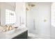 Bathroom featuring decorative white tiling, a gold shower system, and a white marble countertop at 3501 W 41St Ave, Denver, CO 80211