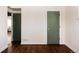 Bright bedroom featuring hardwood floors, white walls, and stylishly painted doors at 3501 W 41St Ave, Denver, CO 80211