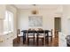 Dining room featuring a modern light fixture, hardwood floors, and a black table with seating for six at 3501 W 41St Ave, Denver, CO 80211